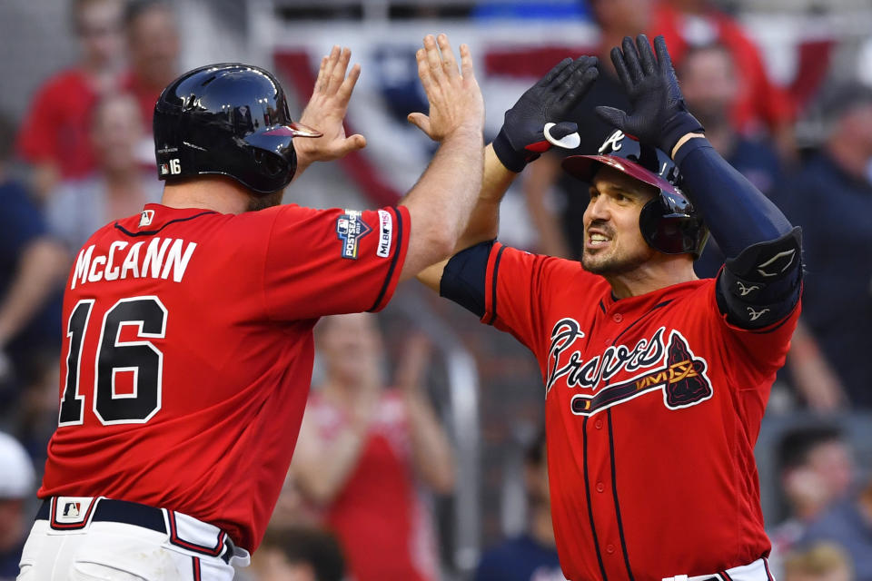 Atlanta Braves Adam Duvall (23) is congratulated by Atlanta Braves Brian McCann (16) after Duvall's two-run homer against the St. Louis Cardinals in the seventh inning during Game 2 of a best-of-five National League Division Series, Friday, Oct. 4, 2019, in Atlanta. (AP Photo/John Amis)
