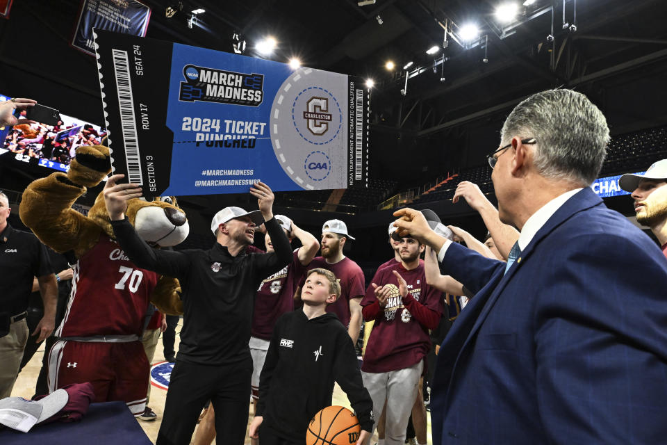 Charleston head coach Pat Kelsey holds a March Madness ticket after defeating Stony Brook in the NCAA college basketball game in the championship of the Coastal Athletic Association conference tournament, Tuesday, March 12, 2024, in Washington. (AP Photo/Terrance Williams)