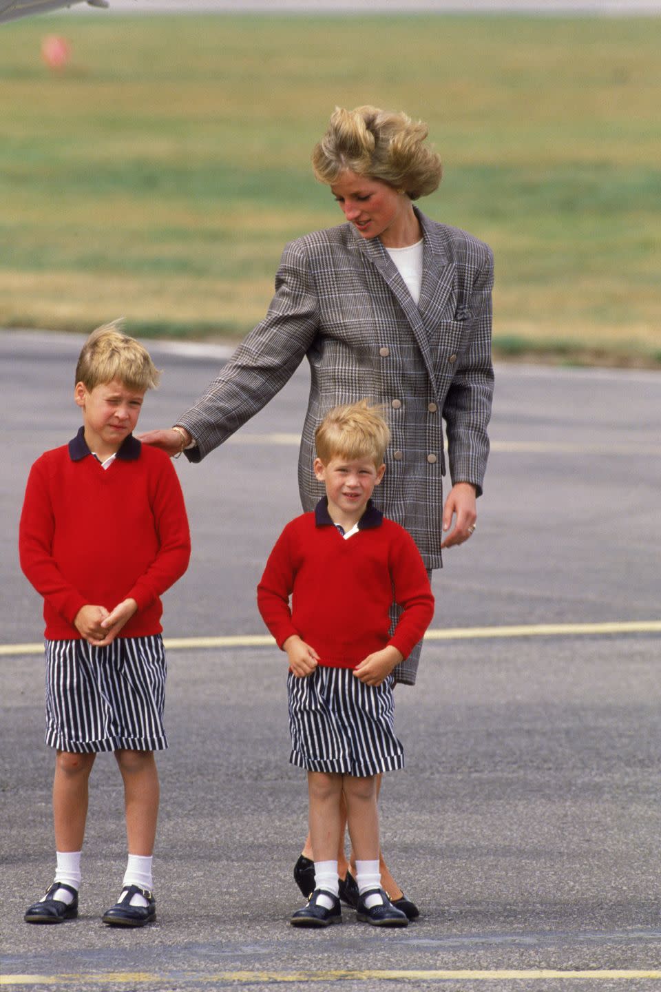 <p>Harry matches with William in striped shorts and red sweaters as they arrive at Aberdeen airport with Princess Diana.</p>