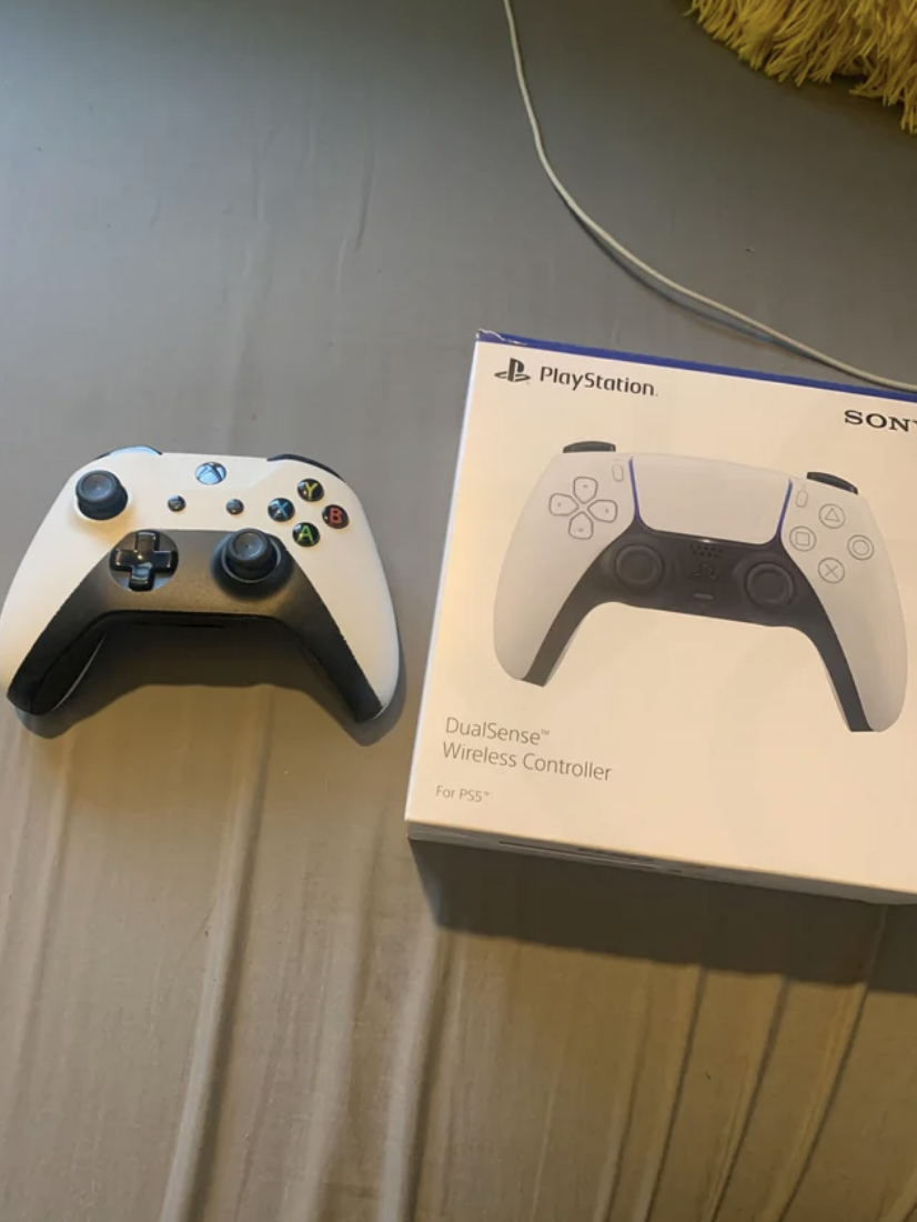the x box controller next to the playstation controller box