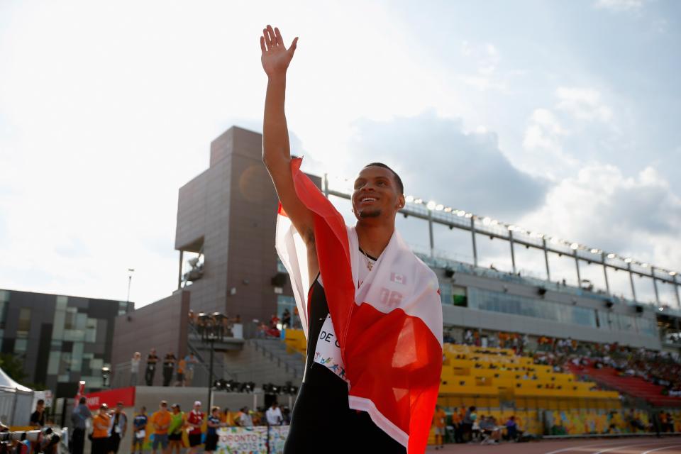  Andre De Grasse of Canada holds the Canadian flag after winning the men&#39;s 200 meter final on Day 14.  (Photo by Ezra Shaw/Getty Images)