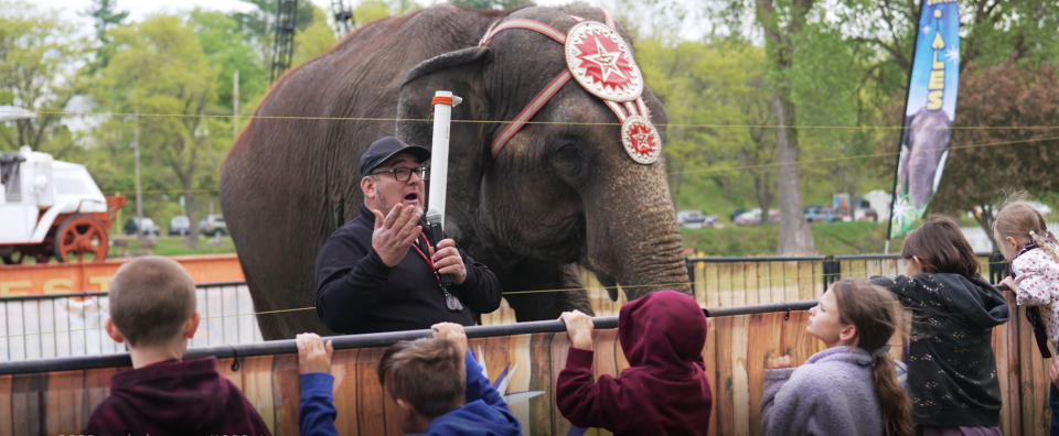 Circus World elephant care superintendent Armando Loyal gives a "Trunk Tales" talk to children, sharing elephant facts.