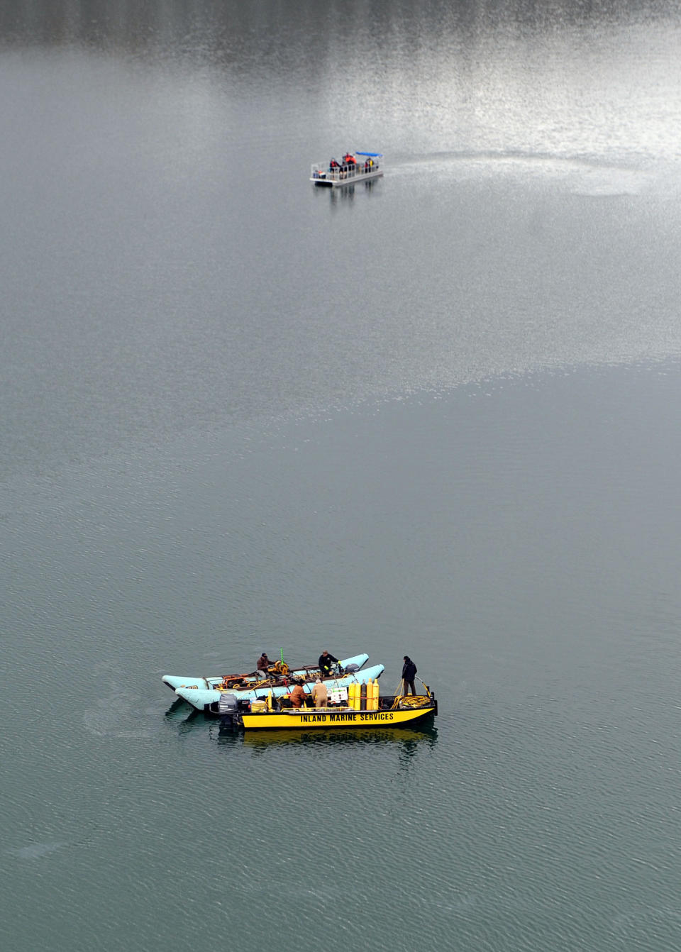 This photo released by Ouray County, shows Ouray County, federal officials and Beegles Aircraft Service Inc. of Greeley, Colo., during salvage operations to recover the victims and plane, Thursday March 27, 2014, at the Ridgway Reservoir near Ridgway, Colo., at the site of a downed aircraft, The plane crashed on Saturday, March 22, 2014, killing five people from Alabama. (AP Photo/Ouray County, William Woody)