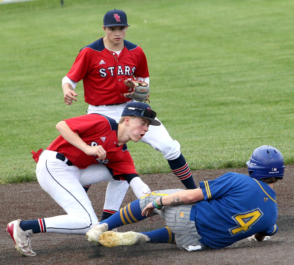 Mitchell's Gibson Glassco (4) slides into second as Bedford North Lawrence's Cam Gates (16) makes the tag. Glassco was out on the play, and BNL defeated Mitchell 5-1 in the annual county rivalry game Friday, May 3, 2024. BNL plays again on May 26, traveling to HHC rival Jennings County.
