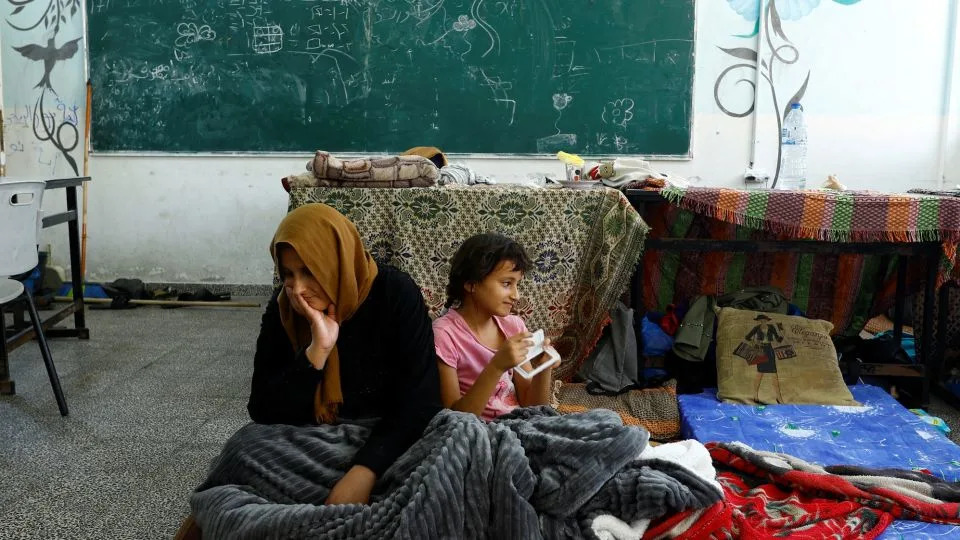 Palestinians, who fled their houses amid Israeli strikes, shelter at a United Nations-run school in Khan Younis in the southern Gaza Strip, October 14. - Ibraheem Abu Mustafa/Reuters