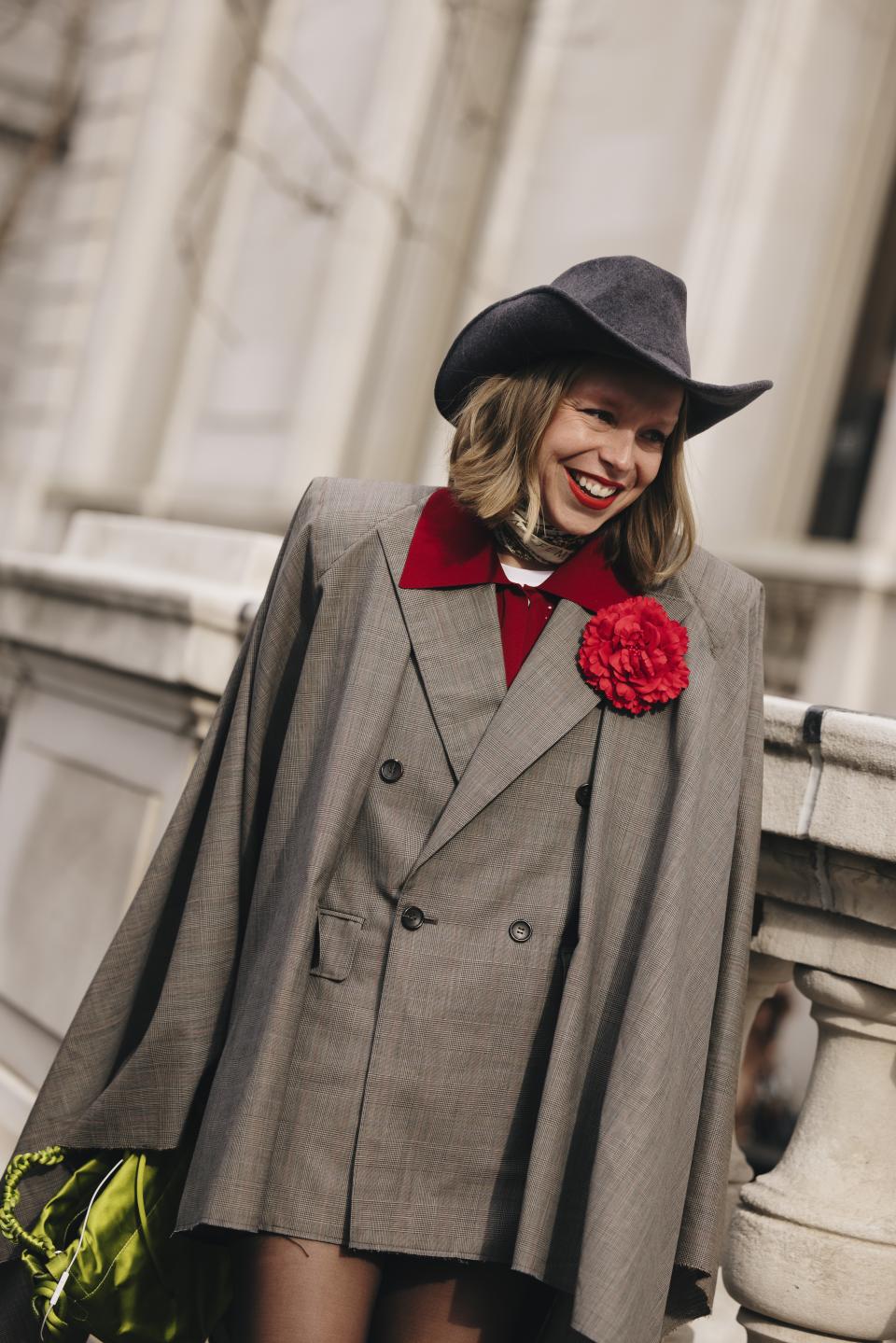 A woman at new york fashion week wearing a brooch in a street style outfit