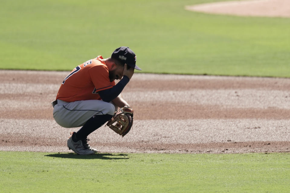 Houston Astros second baseman Jose Altuve reacts after Tampa Bay Rays Manuel Margot hit a three run home run against Astros starting pitcher Lance McCullers Jr. during the first inning in Game 2 of a baseball American League Championship Series, Monday, Oct. 12, 2020, in San Diego. (AP Photo/Jae C. Hong)