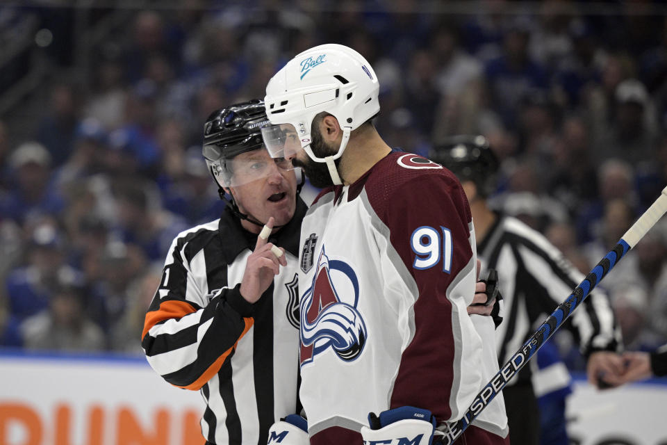 Referee Kelly Sutherland talks to Colorado Avalanche center Nazem Kadri during the second period of Game 6 of the NHL hockey Stanley Cup Finals against the Tampa Bay Lightning on Sunday, June 26, 2022, in Tampa, Fla. (AP Photo/Phelan Ebenhack)