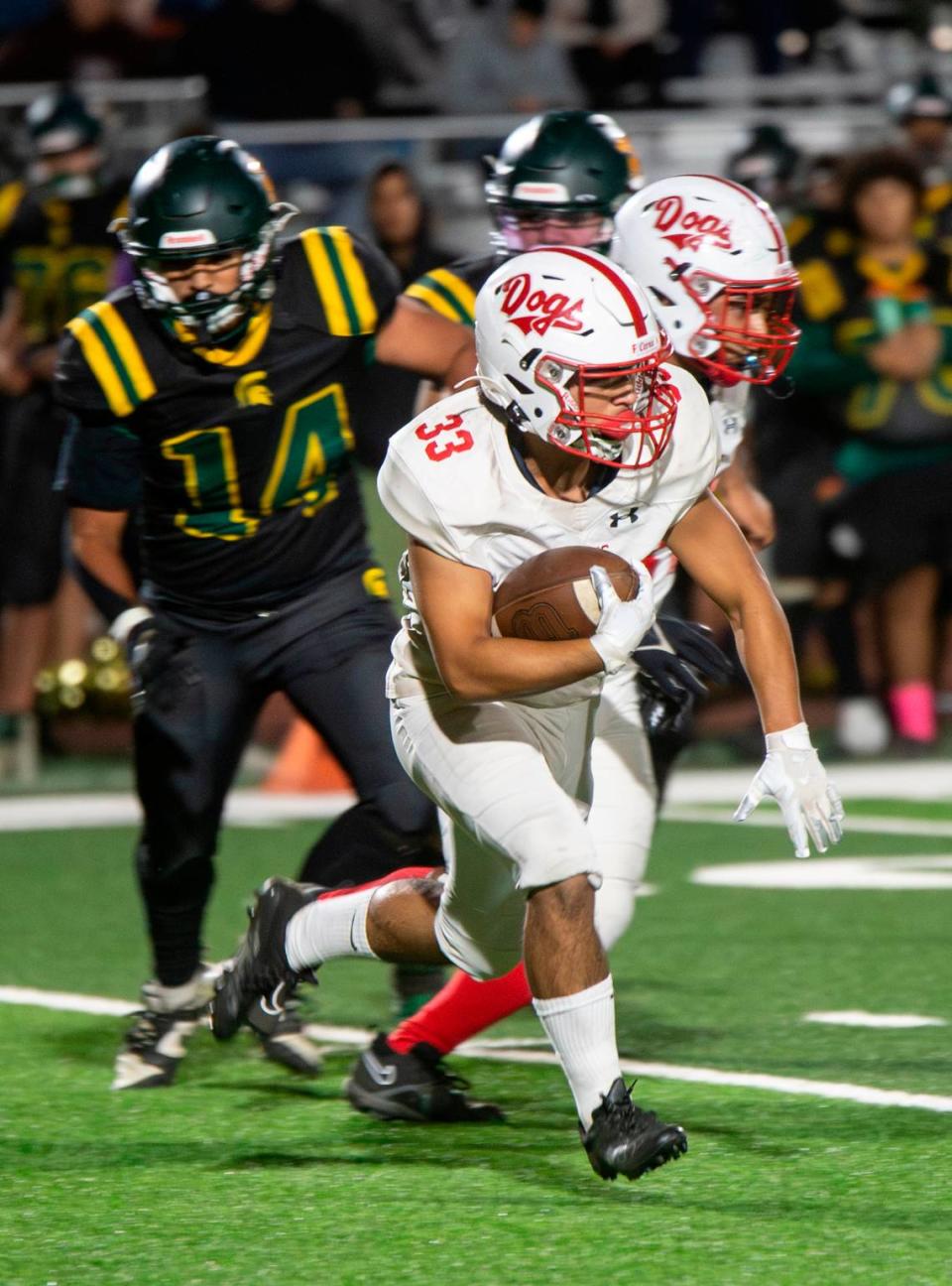 Isaac Vizcarra (33) of Ceres High works his way upfield during a WAC game against Davis High on Friday Oct. 27, 2023. 