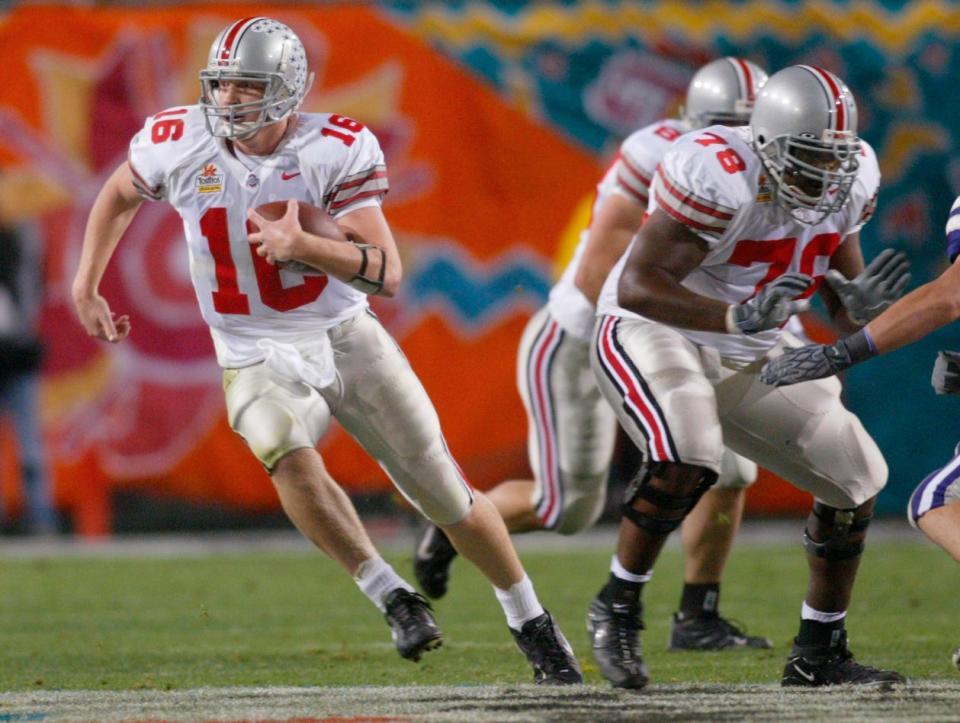(fiesta may munden 1/2/2004) Ohio State's Craig Krenzel, 16, runs for a first down in the second quarter of the 2004 Fiesta Bowl in Tempe, Az. (Dispatch photo by Mike Munden)