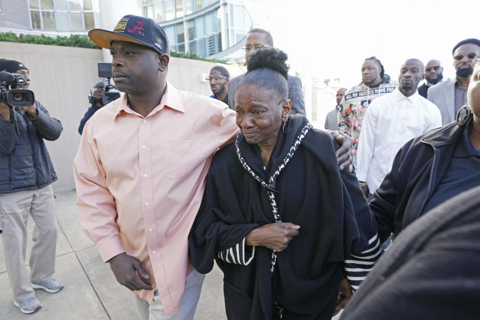 Eddie Terrell Parker, left, escorts Mary Jenkins, mother of Michael Corey Jenkins, into the Thad Cochran United States Courthouse in Jackson, Miss., Tuesday, March 19, 2024, for sentencing on two of the six former Mississippi Rankin County law enforcement officers who committed numerous acts of racially motivated, violent torture on Parker and his friend Jenkins in 2023. The six former law officers pleaded guilty to a number of charges for torturing them and sentencing begins Tuesday in federal court. (AP Photo/Rogelio V. Solis)