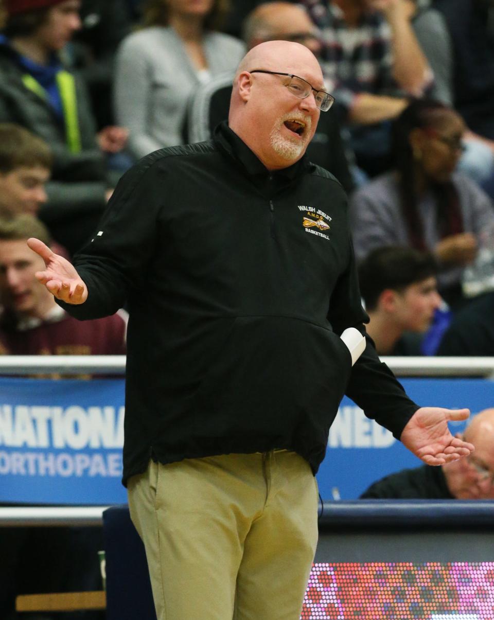 Walsh Jesuit boys basketball head coach Kevin Byrne gestures as he talks with a referee during a 2023 regional final against Hoban at Kent State.