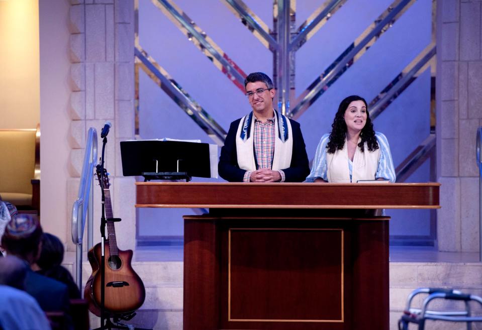 Rabbis Ryan Daniels, left, and Carlie Daniels lead Shabbat services at Temple Israel on Aug. 18.