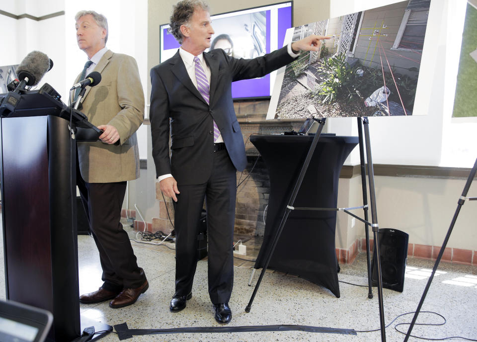 FILE - In this July 25, 2019 file photo Mike Doyle, left, and Chuck Bourque, lawyers for the victims who were killed in a drug raid earlier this year by Houston police, talk about forensic results from a private firm in Houston. A former Houston police officer has been charged with felony murder in connection with a deadly January drug raid that killed a couple and injured several officers, prosecutors announced Friday, Aug. 23. Killed in the shooting were 58-year-old Rhogena Nicholas and 59-year-old Dennis Tuttle. (Elizabeth Conley/Houston Chronicle via AP)