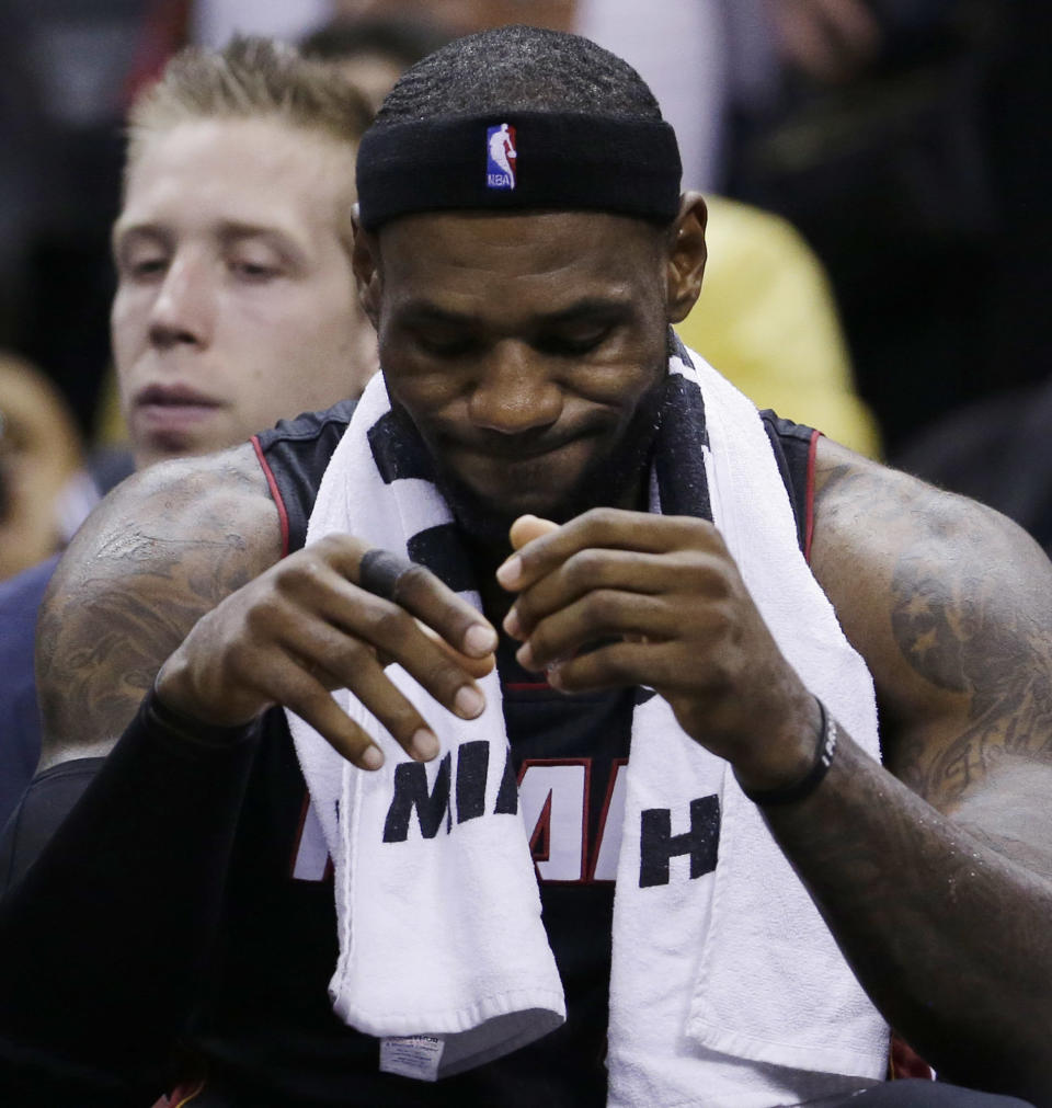 Miami Heat forward LeBron James sits on the bench during the second half in Game 5 of the NBA basketball finals against the San Antonio Spurs on Sunday, June 15, 2014, in San Antonio. The Spurs won the NBA championship 104-87. (David J. Phillip)