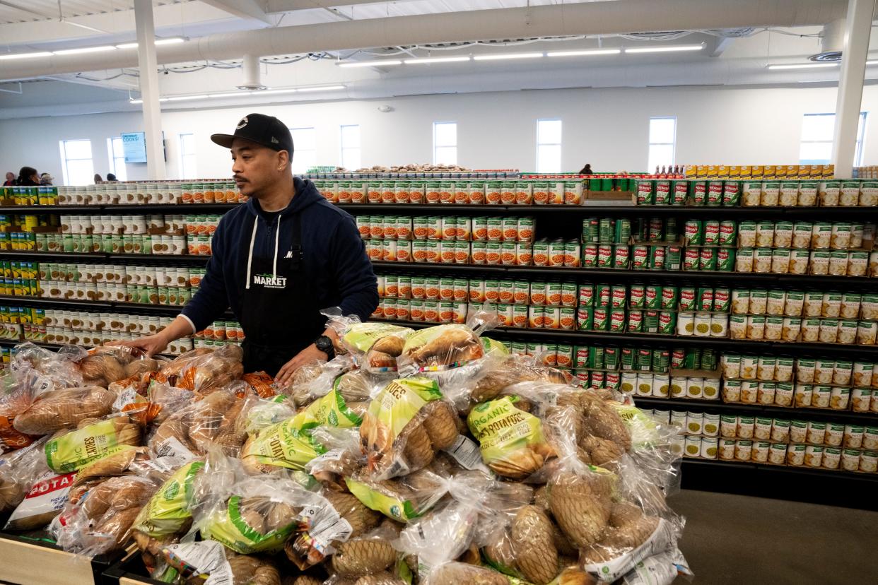 Michael Urriquia, Freestore Foodbank volunteer, works inside the grocery store at the Freestore Foodbank in Cincinnati on Tuesday, Feb. 20, 2024.