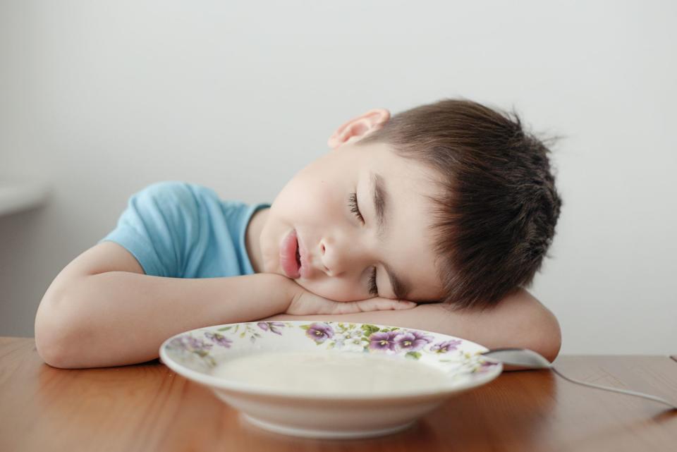 child sleeping at table