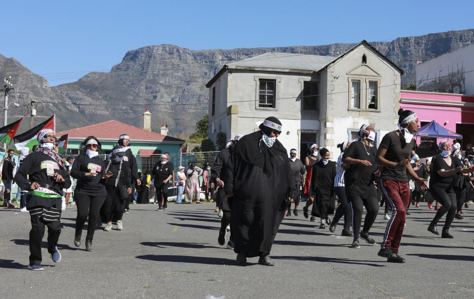 People dance to Jerusalema in Cape Town, South Africa, Thursday, Sept. 24, 2020. South Africans of all walks of life are dancing to “Jerusalema,” a rousing anthem to lift their spirits amid the battle against COVID-19. In response to a call from President Cyril Ramaphosa to mark the country’s Heritage Day holiday Thursday, people from townships to posh suburbs are doing line dances to the tune. (AP Photo/Nardus Engelbrecht)