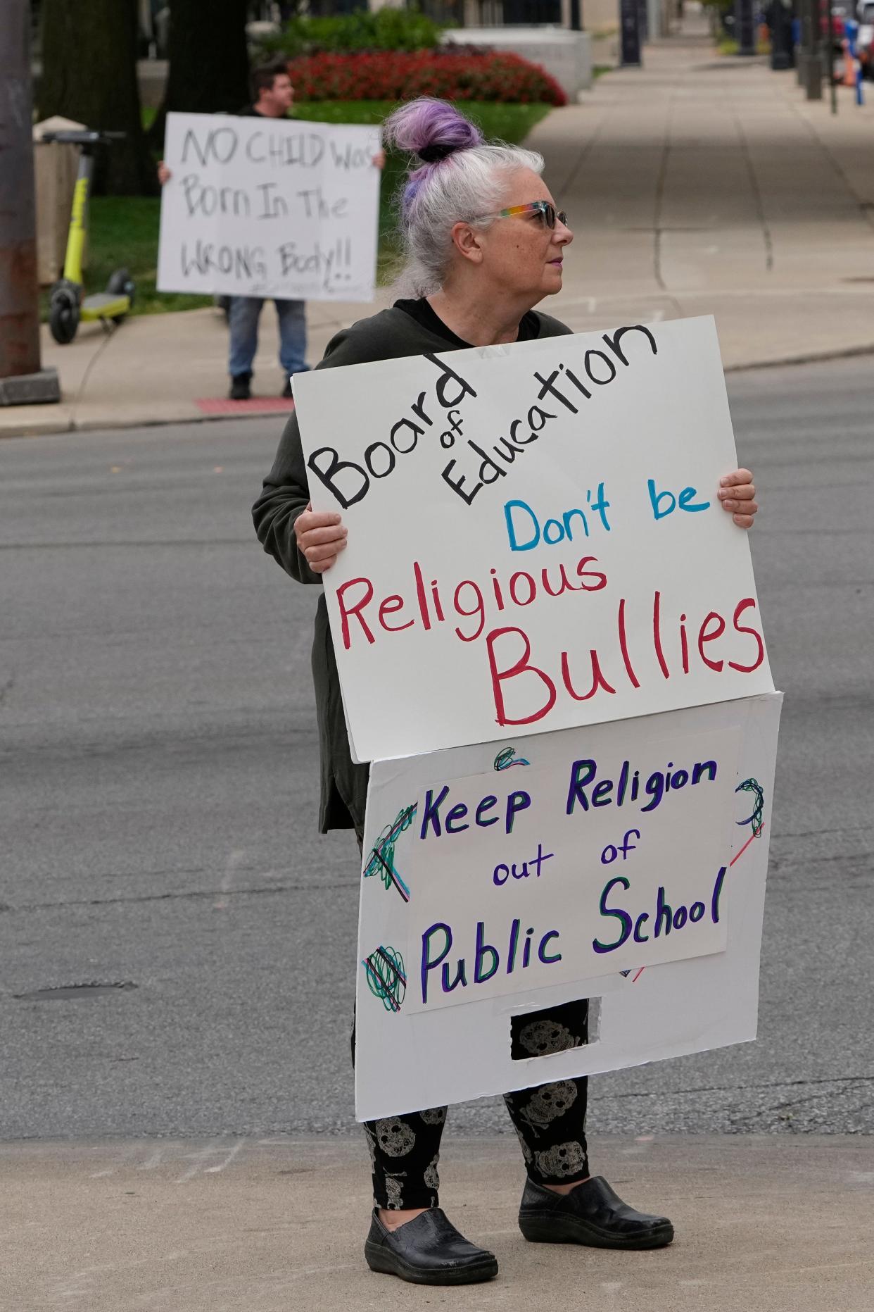 Gwen Jones and LGBTQ+ allies protest outside the Ohio Department of Education building Wednesday as the board hears public testimony on a resolution that opposes proposed changes to Title IX, the federal law that prohibited discrimination in schools on the basis of sex. Adam Cairns/The Columbus Dispatch