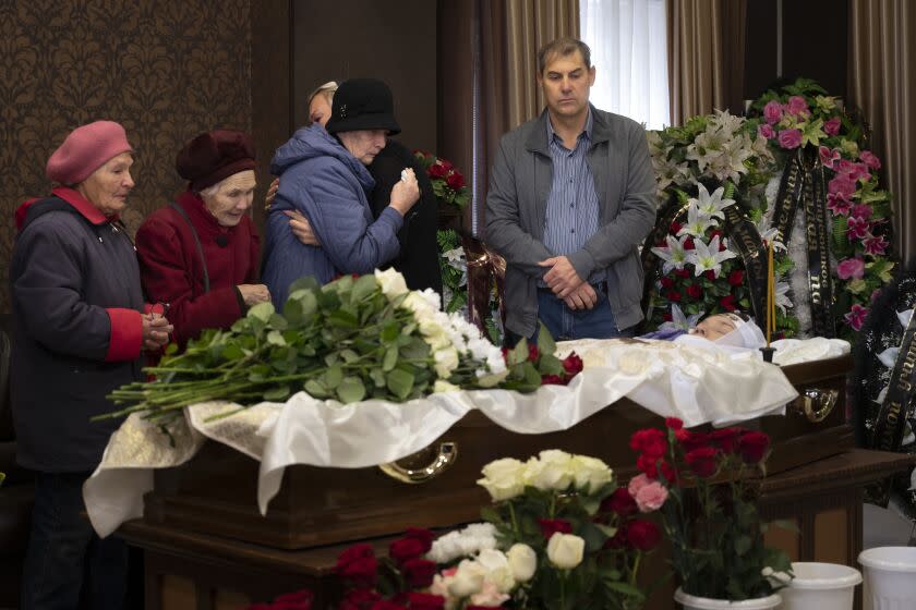 Relatives and friends react as they attend a farewell to teacher Natalya Vedernikova, one of victims of the shooting at school No. 88, in Izhevsk, Russia, Wednesday, Sept. 28, 2022. The shooting in Monday took place in School No. 88 in Izhevsk, a city 960 kilometers (600 miles) east of Moscow in the Udmurtia region, and was one of the deadliest school shootings in Russia. (AP Photo/Dmitry Serebryakov)