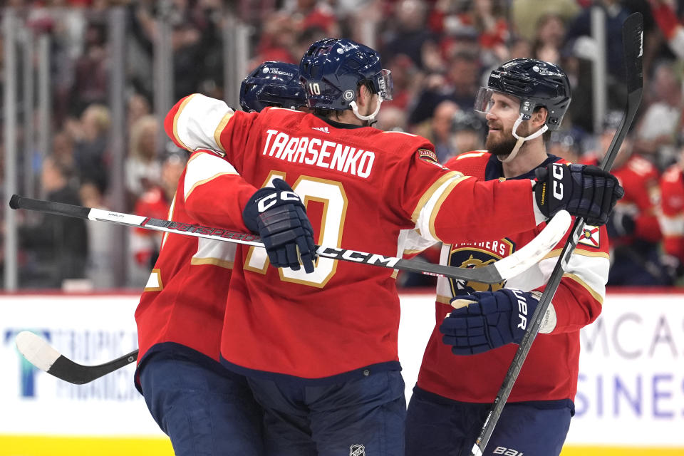 Florida Panthers right wing Vladimir Tarasenko (10) is congratulated by defenseman Oliver Ekman-Larsson, right, after scoring a goal during the second period of an NHL hockey game against the Calgary Flames, Saturday, March 9, 2024, in Sunrise, Fla. (AP Photo/Lynne Sladky)