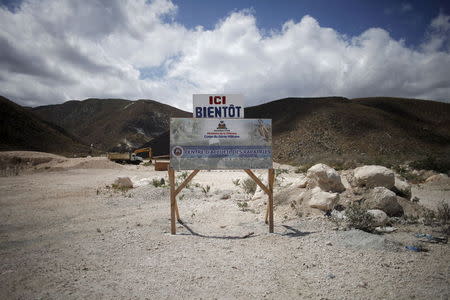 A sign at the site of a planned repatriation center reads "Here soon" near the border between Dominican Republic and Haiti, in Malpasse, Haiti, August 3, 2015. REUTERS/Andres Martinez Casares