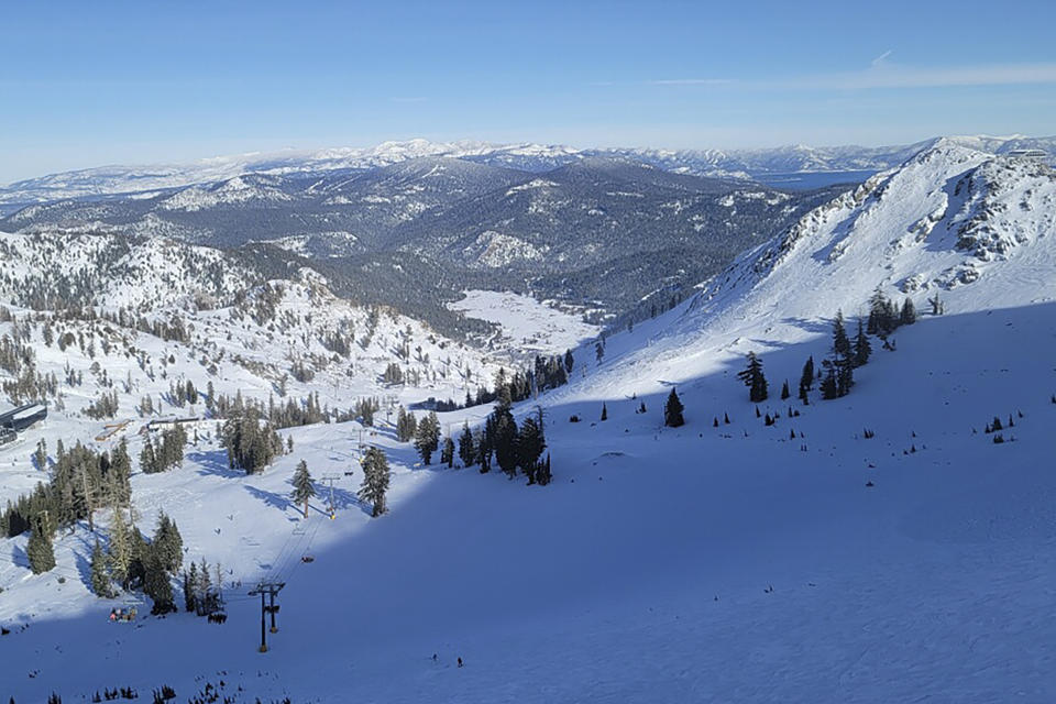 ADDS NAME OF SKI RESORT - Skiers take a lift to the top of a mountain near Palisades Tahoe, a California ski resort near Lake Tahoe, on Thursday, Jan. 11, 2024, in Calif. After closing down every lift and trail in the avalanche's aftermath, Palisades Tahoe reopened many runs on Thursday. But its iconic KT-22 lift, which serves the area of mostly expert runs where the slide occurred, remained closed while crews worked to clear a road to enable snowcats and snowmobiles to enter and clean up. (Mark Sponsler via AP)