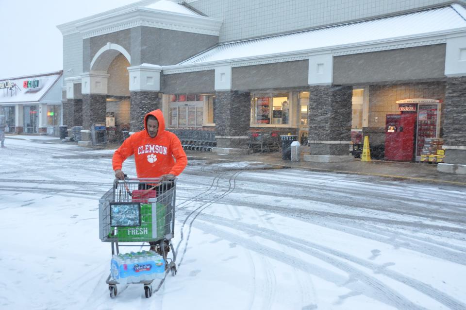 Victor Crews pushes his cart across the snow-covered parking lot at Acme supermarket in the Smyrna Mart shopping center on Glenwood Avenue Jan. 19 at about 7:30 a.m., when nearly 1.5 inches of snow had fallen. The Smyrna area received about 5 inches of snow that day.