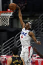 Los Angeles Clippers guard Terance Mann (14) slam dunks the ball over Toronto Raptors forward Yuta Watanabe, of Japan, (18) during the second half of an NBA basketball game Tuesday, May 11, 2021, in Tampa, Fla. (AP Photo/Chris O'Meara)