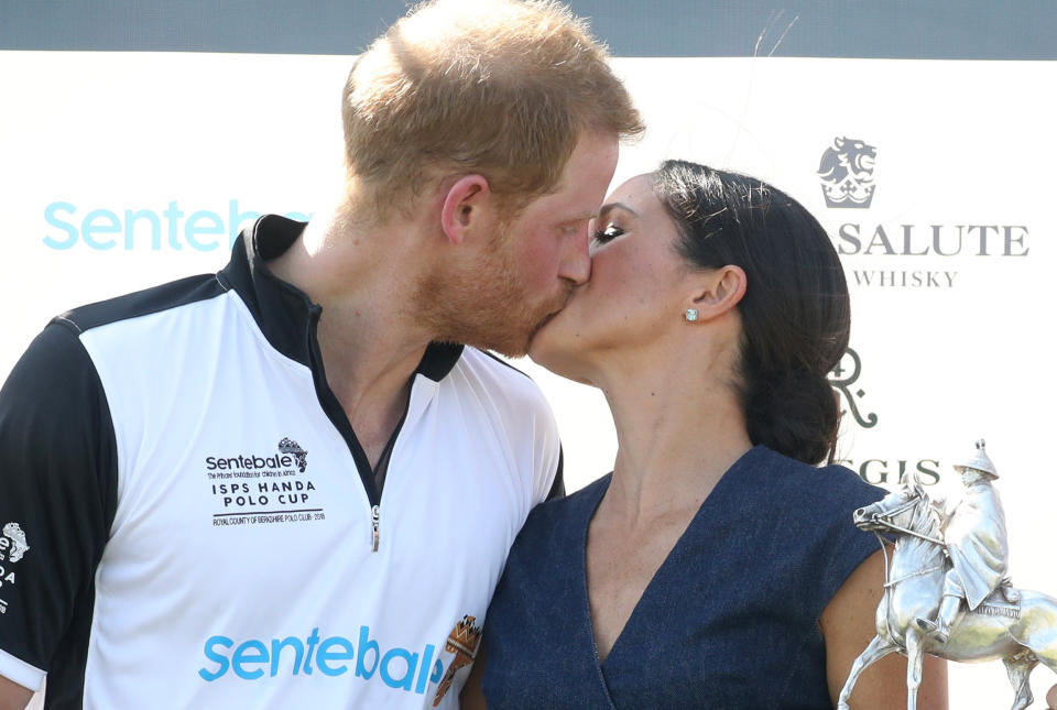 Meghan, Duchess of Sussex and Prince Harry kiss after posing with the trophy after the Sentebale Polo Cup&nbsp;on July 26 in Windsor, England.&nbsp; (Photo: Chris Jackson via Getty Images)