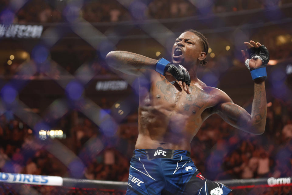 Jul 29, 2023; Salt Lake City, Utah, USA; Kevin Holland (blue gloves) reacts to defeating Michael Chiesa (red gloves) during UFC 291 at Delta Center. Mandatory Credit: Jeff Swinger-USA TODAY Sports