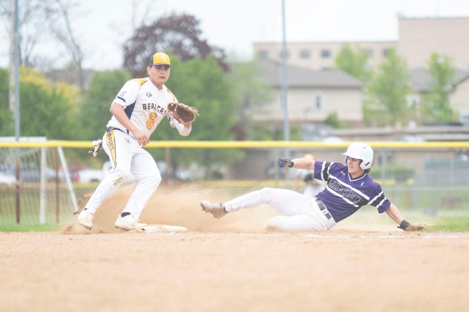 Lakeview senior Zach Kucharczyk slides into third base while Battle Creek Central's Juan Romero during a game against Lakeview at Battle Creek Central High School on Thursday, May 2, 2024.