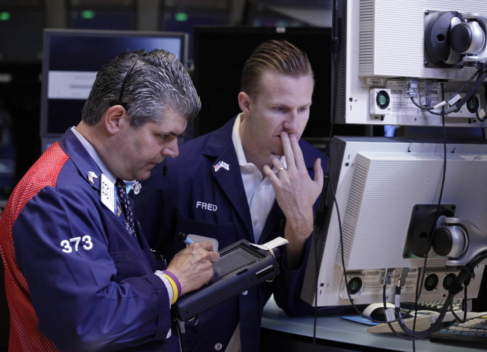 Trader John Panin, left, and specialist Frederick Edwards work on the floor of the New York Stock Exchange Friday, June 1, 2012. Stocks fell sharply Friday after the release of a dismal report on job creation in the United States. The Dow Jones industrial average dropped more than 200 points, erasing what was left of its gain for the year. (AP Photo/Richard Drew)