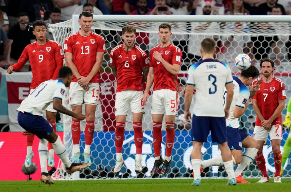 England's Marcus Rashford, front left, scores his side's opening goal during the World Cup group B football match between England and Wales, at the Ahmad Bin Ali Stadium in Al Rayyan, Qatar, Tuesday, Nov. 29, 2022. (AP Photo/Thanassis Stavrakis)