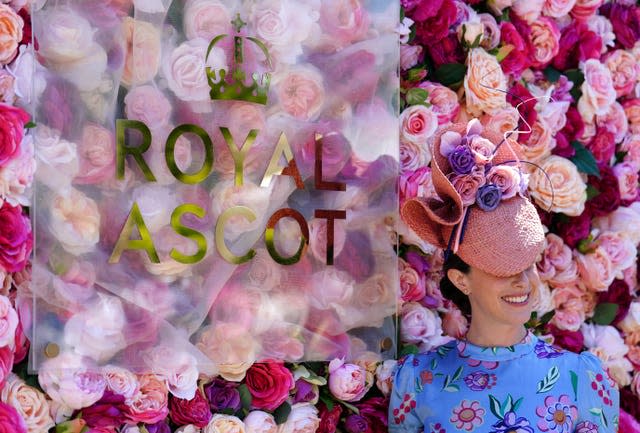 A racegoer poses for a photograph ahead of day one of Royal Ascot