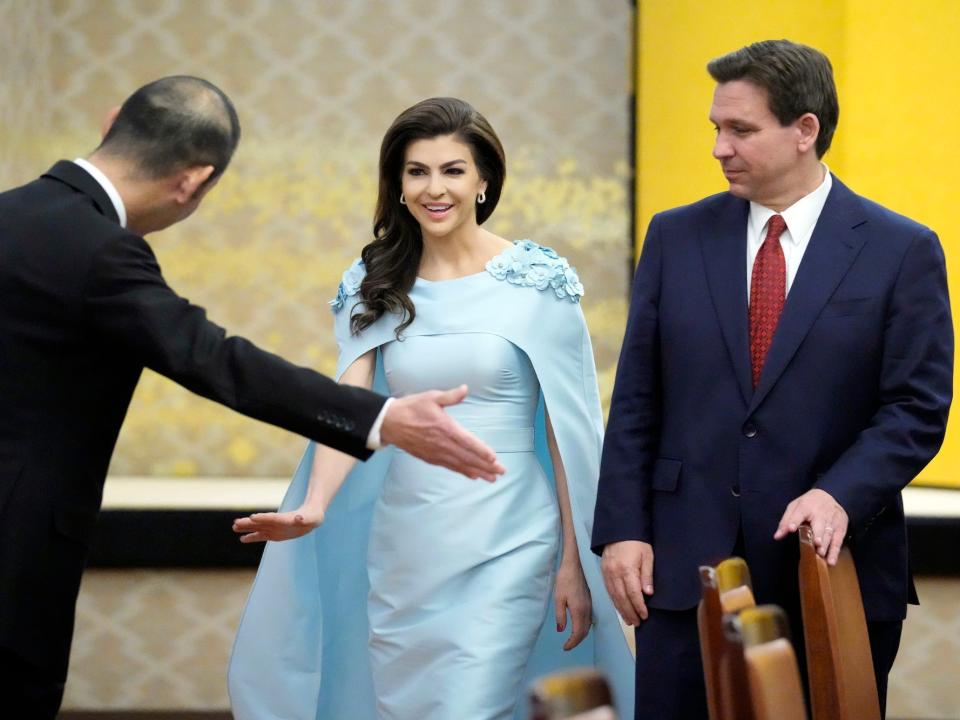 Florida Gov. Ron DeSantis, right, and his wife Casey are escorted to their seats for a meeting with Japanese Foreign Minister Yoshimasa Hayashi, not in picture, at Iikura Guest House Monday, April 24, 2023, in Tokyo.