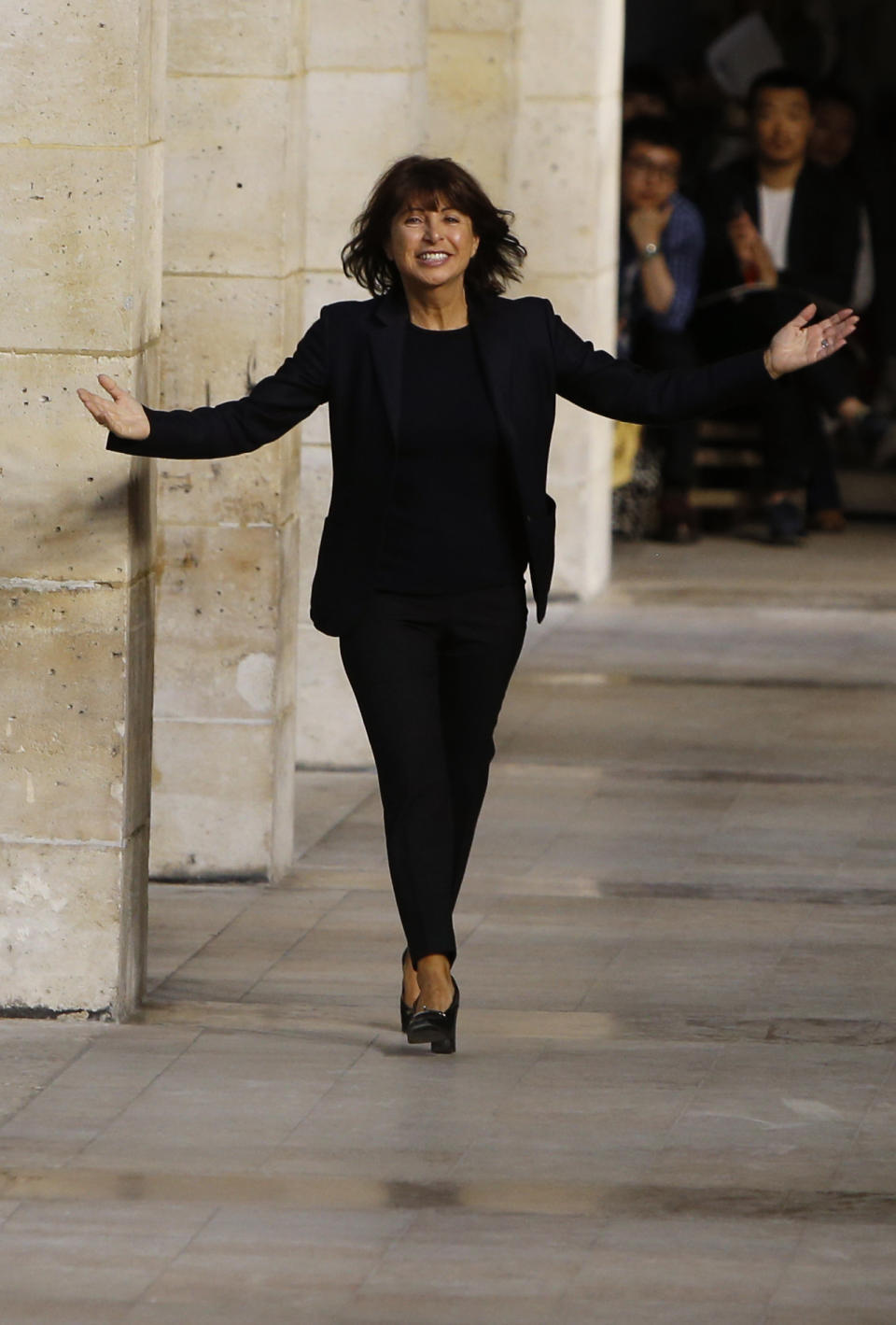 French fashion designer Veronique Nichanian gestures as she acknowledges applause at the end of Hermes men's fashion Spring-Summer 2014 collection, presented Saturday, June 29, 2013 in Paris. (AP Photo/Francois Mori)