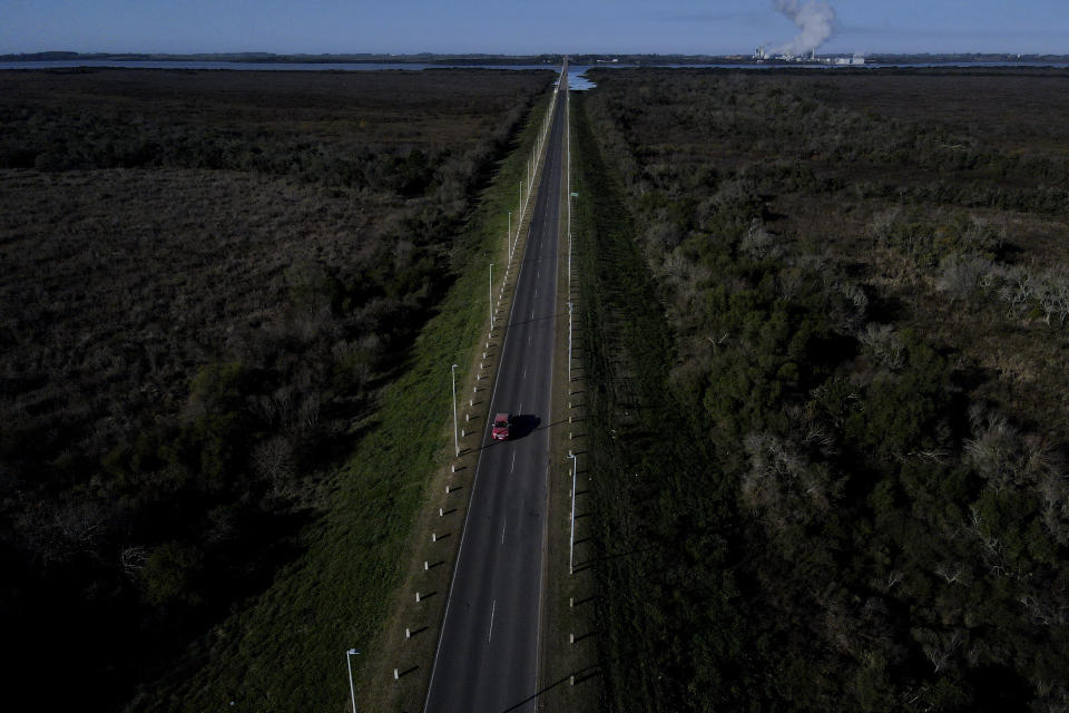 A car leaves Uruguay, top, and approaches Gualeguaychu, Argentina, in the Entre Rios province of Argentina, Saturday, July 1, 2023. Uruguayans are crossing the border to Argentina for shopping bargains created by different exchange rates in the South American countries as crisis-battered Argentina’s peso has plunged against the U.S. dollar and its annual inflation tops 100%, one of the highest rates in the world. (AP Photo/Natacha Pisarenko)