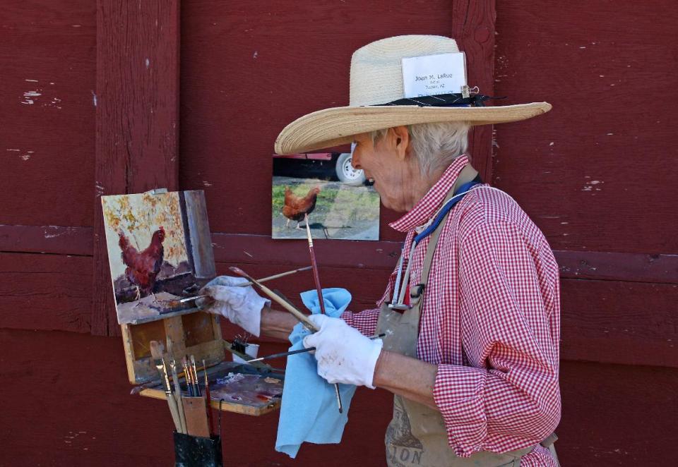 This Aug. 20, 2011 photo shows Joan LaRue of Tucson, Ariz., participating in Quick Draw at the Sieben Ranch north of Helena, Mont. Quick Draw, an event in which artists create works outdoors in public in a matter of hours, is part of an annual August art festival called the Western Rendezvous of Art centered in Helena. (AP Photo/Ron Zellar)