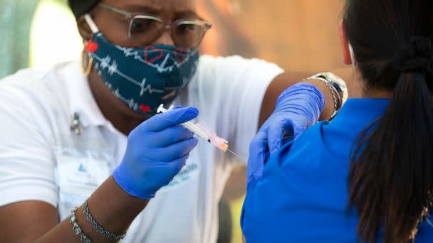 PHOTO:A Licensed Vocational Nurse Theresa Jackson, left, is pictured giving  flu shots at San Fernando Middle School, Oct.16, 2020 in San Francisco. (Francine Orr/Los Angeles Times via Getty Images)