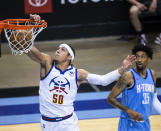 Denver Nuggets forward Aaron Gordon (50) dunks past Houston Rockets center Christian Wood (35) during the first quarter of an NBA basketball game Friday, April 16, 2021, in Houston. (Mark Mulligan/Houston Chronicle via AP)