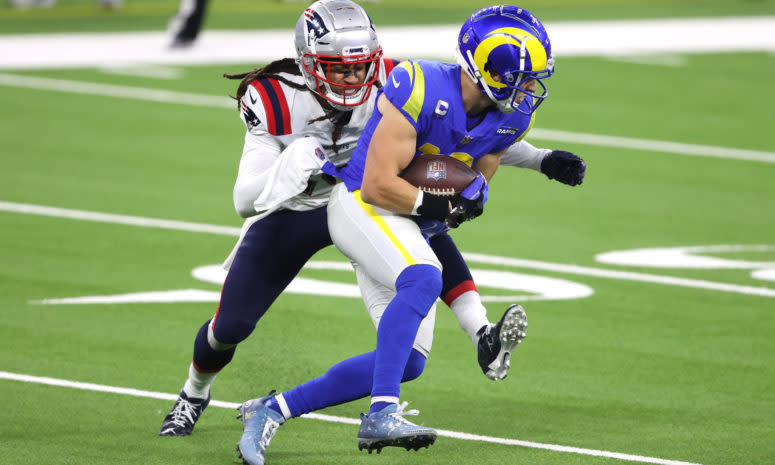 Rams WR Cooper Kupp is tackled by a member of the Patriots.