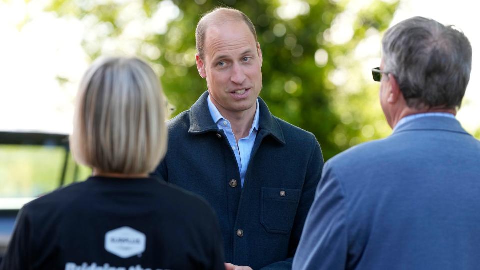 Prince William smiles as he arrives at Surplus to Supper