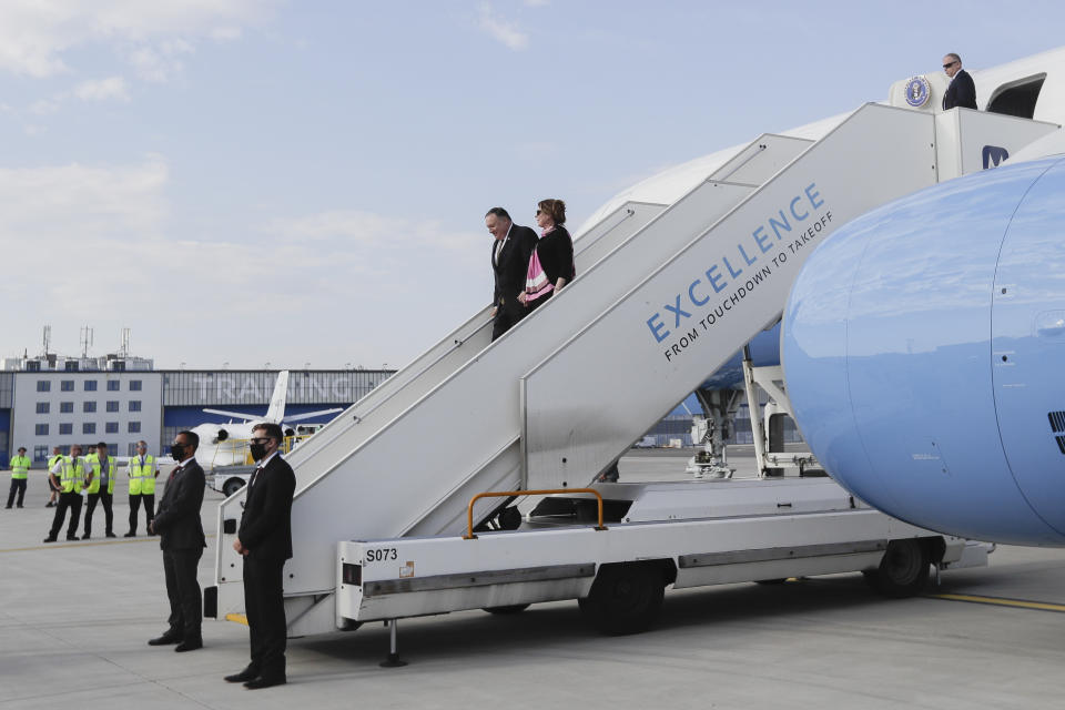 U.S. Secretary of State Mike Pompeo, center left, arrives with his wife Susan Pompeo, center right, at the airport in Prague, Czech Republic, Tuesday, Aug. 11, 2020. U.S. Secretary of State Mike Pompeo is in Czech Republic at the start of a four-nation tour of Europe. Slovenia, Austria and Poland the other stations of the trip. (AP Photo/Petr David Josek, Pool)