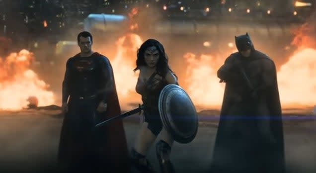 Superman, Wonder Woman, and Batman standing together in front of a wall of fire in "Batman v Superman: Dawn of Justice"