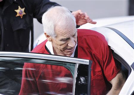 Jerry Sandusky leaves the Centre County Courthouse after his sentencing in his child sex abuse case in Bellefonte, Pennsylvania October 9, 2012. REUTERS/Pat Little