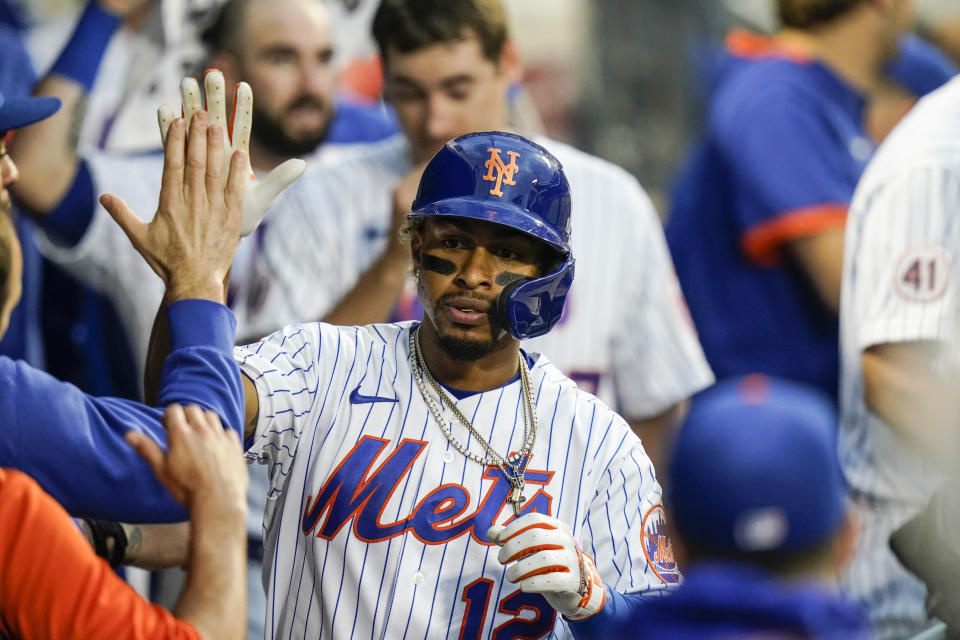 New York Mets' Francisco Lindor (12) celebrates with teammates after hitting a two-run home run during the sixth inning in the first baseball game of a doubleheader against the Miami Marlins Tuesday, Sept. 28, 2021, in New York. The Mets won 5-2. (AP Photo/Frank Franklin II)