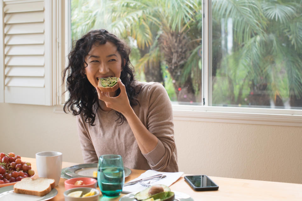 A woman eating avocado toast