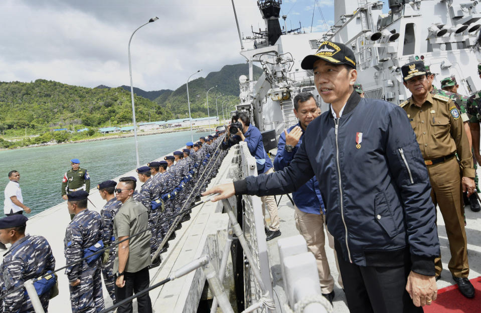 In this photo released Indonesian Presidential Office, Indonesian President Joko Widodo, second right, stands on the deck of Indonesian Navy ship KRI Usman Harun at Selat Lampa Port, Natuna Islands, Indonesia, Wednesday, Jan. 8, 2020. Indonesian President Joko Widodo on Wednesday visited the Natuna islands that overlap with China's expansive claim to the South China Sea amid heightened tensions over the waters after Beijing recently claimed it was their traditional fishing area. (Agus Soeparto, Indonesian Presidential Office via AP)