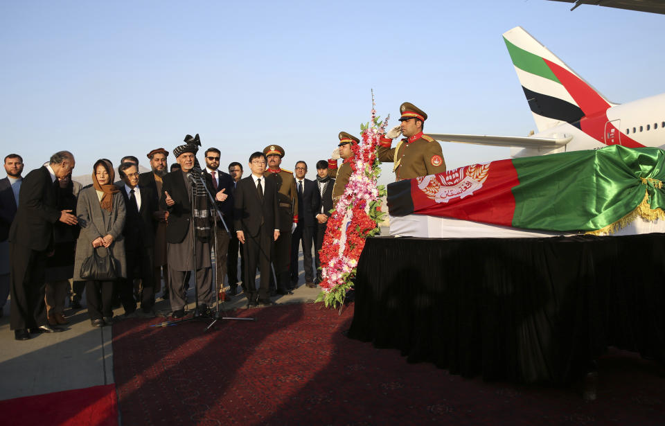 Afghan President Ashraf Ghani, speaks, next to the coffin of Japanese physician Tetsu Nakamura during a ceremony before transporting his body to his homeland, at the Hamid Karzai International Airport in Kabul, Afghanistan, Saturday, Dec. 7, 2019. Nakamura was killed earlier this week in a roadside shooting in eastern Afghanistan. (AP Photo/Rahmat Gul)